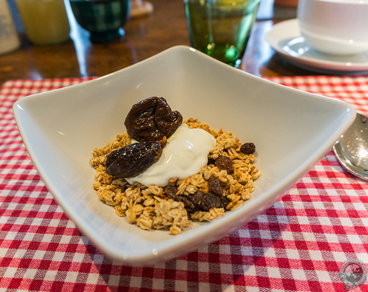 Granola, cream, and plums