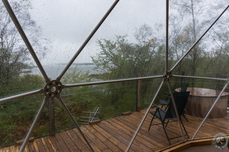 Looking out the wide front window over the deck, hot tub, and Castle Stalker