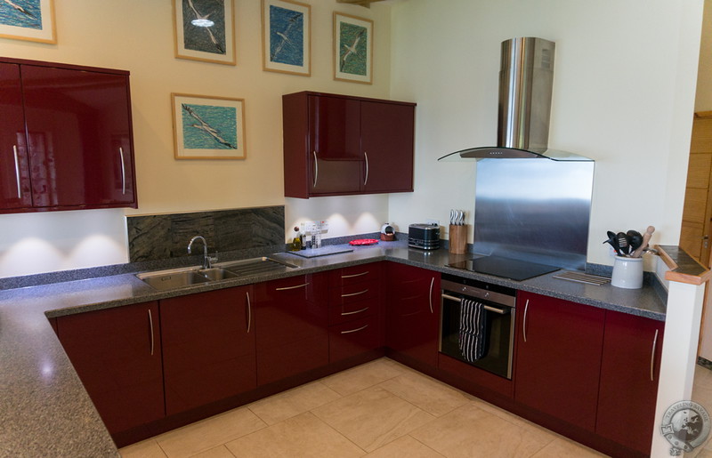 A high-end kitchen leads to the dining area