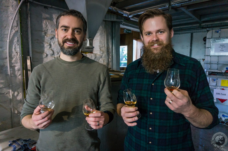 Two guys learning how to make whisky while drinking whisky in Scotland