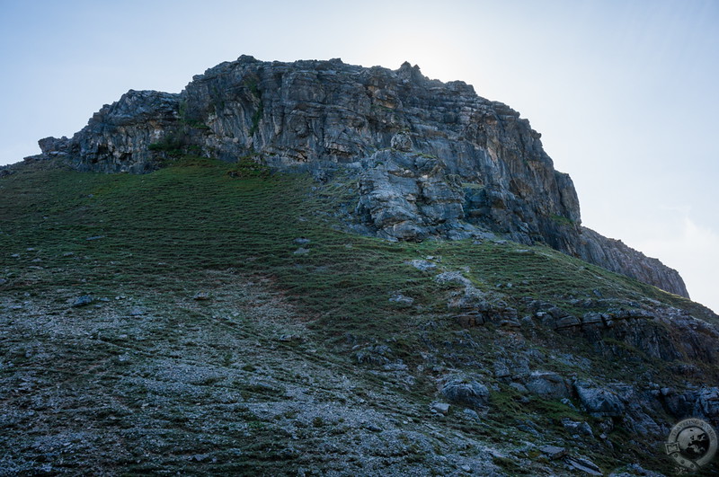 A stone giant resets atop the crag